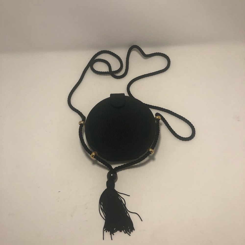 Black, Circular Mini Shoulder Purse with Gold-Tone Accents.